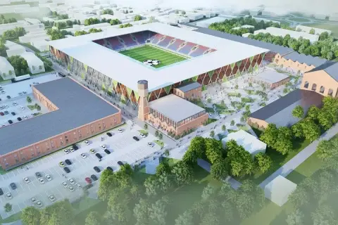 Nowy stadion Rakowa z imponującą pojemnością, otoczony historyczną architekturą i nowoczesnymi przestrzeniami.
