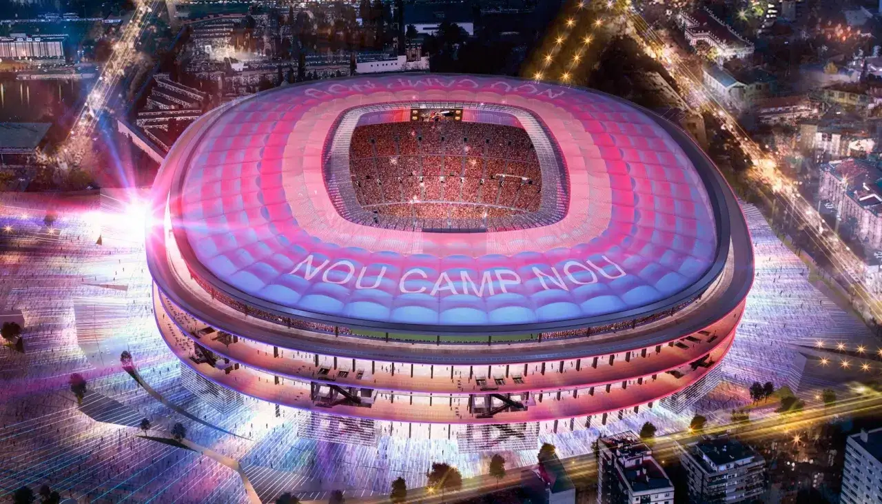 Niesamowity widok na nowe Camp Nou nocą, oświetlone w barwach klubu. Trybuny wypełnione kibicami, a na dachu widnieje napis